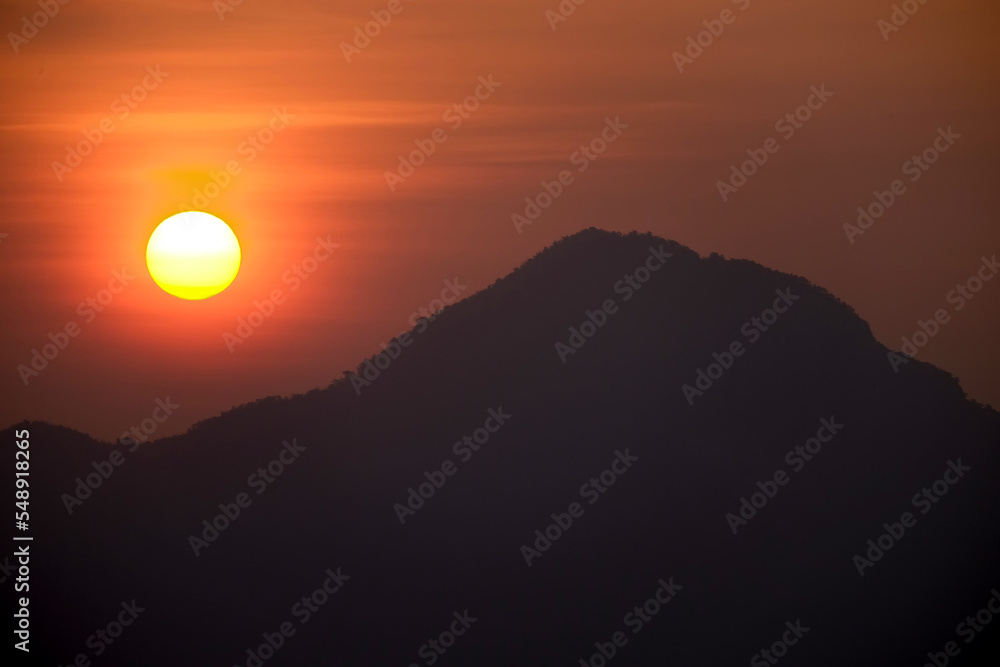 The sun rises behind the mountain 1