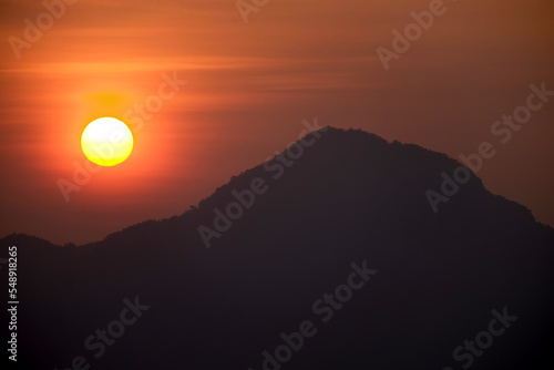 The sun rises behind the mountain 1