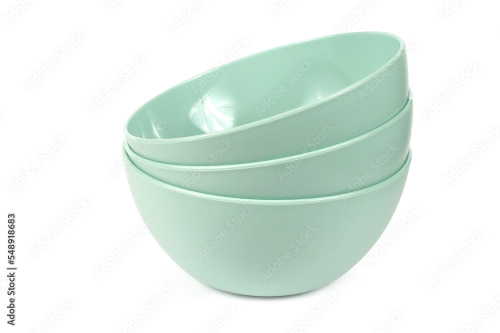 Plastic plates on a white background. Three modern plastic plates. Dishes close-up. Plastic plates on a white background. Three modern plastic plates. Dishes close-up.