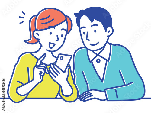 スマホであれこれショッピングする若い夫婦