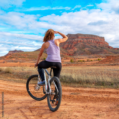 Cyclist riding a bike in the desert ( sierra armantes, Aragon in Spain- Zaragoza province) photo