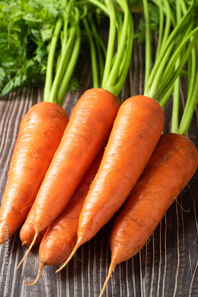Fresh carrots on rustic background. Healthy vegetable food. Fresh carrots on rustic background. Healthy vegetable food.