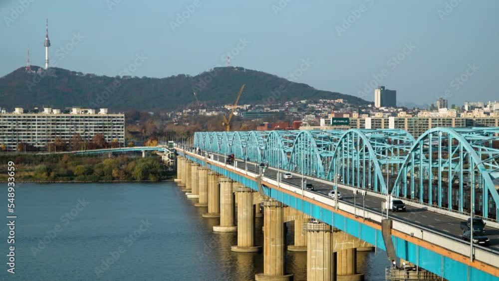 Commuter traffic drives across Dongjak Bridge over Han River, Seoul South Korea.