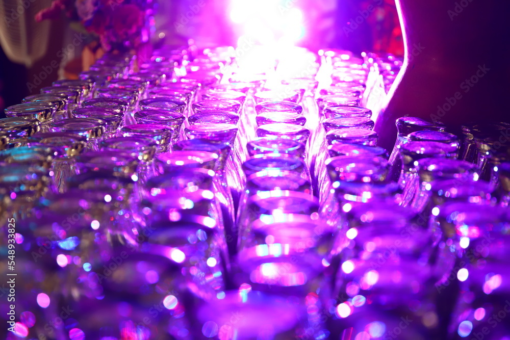 Defocused blurred abstract background, The glasses are neatly arranged against a very bright light background Defocused blurred abstract background, The glasses are neatly arranged against a very bright light background