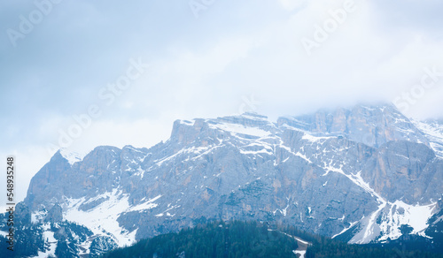 Mountain peaks with snow against a cloudy sky