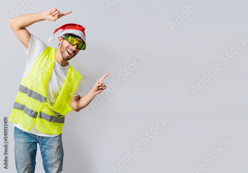 Wallpaper Mural Builder worker with christmas hat pointing a christmas promotion