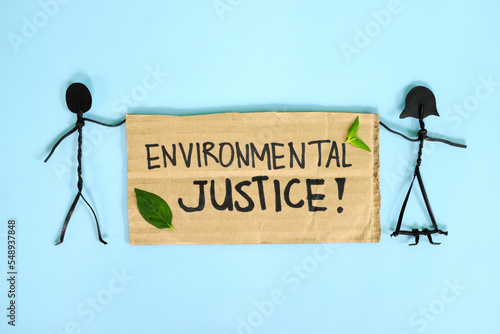 Environmental justice, ecological and climate justice concept. People stick figures protesting while holding a carton placard.
