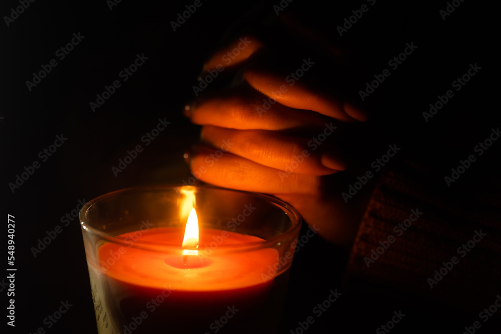 woman with candle on dark background, calm girl praying, Christmas holidays concept woman with candle on dark background, calm girl praying, Christmas holidays concept