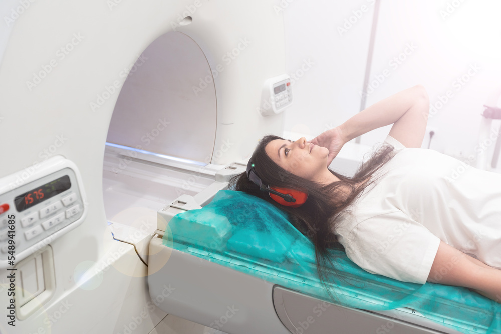 Medical CT or MRI Scan in the modern hospital laboratory. Interior of radiography department. Technologically advanced equipment in white room. Magnetic resonance diagnostics machine Medical CT or MRI Scan in the modern hospital laboratory. Interior of radiography department. Technologically advanced equipment in white room. Magnetic resonance diagnostics machine
