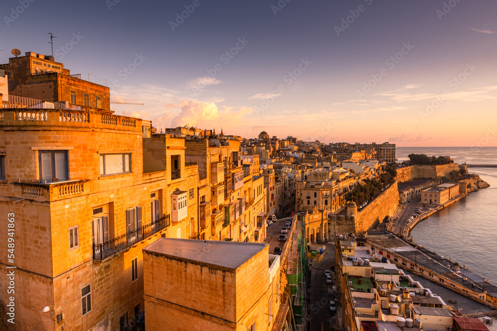 Sunrise at the Grand Harbour of Malta with the ancient walls of Valletta