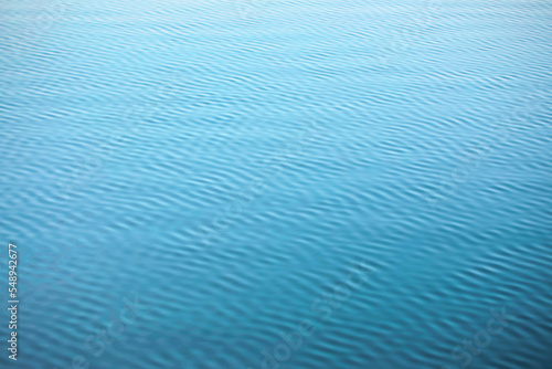 Turquise sea texture - wave pattern, gentle wind ripples the surface of the water. Parallel and diagonal lines.