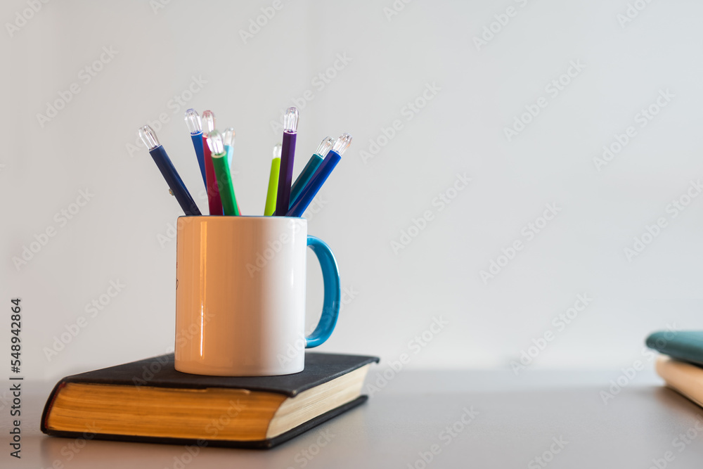 book and a cup with pencils book and a cup with pencils
