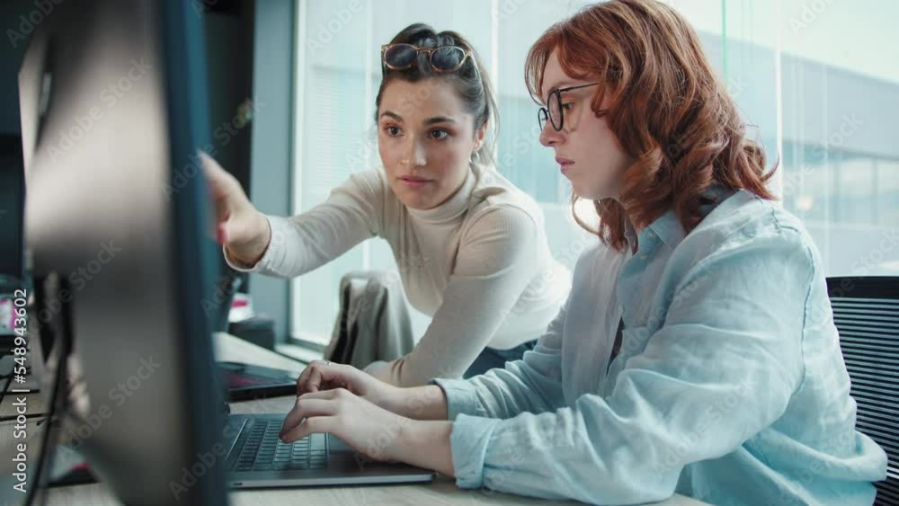 Business women having a discussion and working on a code. Female ...