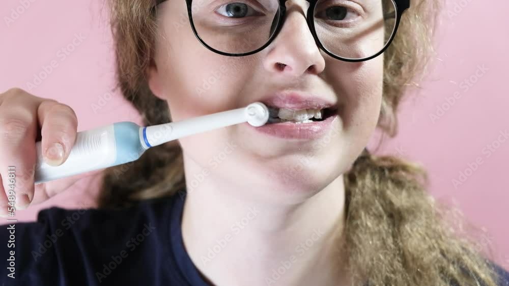 Close Up Of Woman Brushing Teeth With Electric Toothbrush Close Up Of Woman Brushing Teeth With Electric Toothbrush