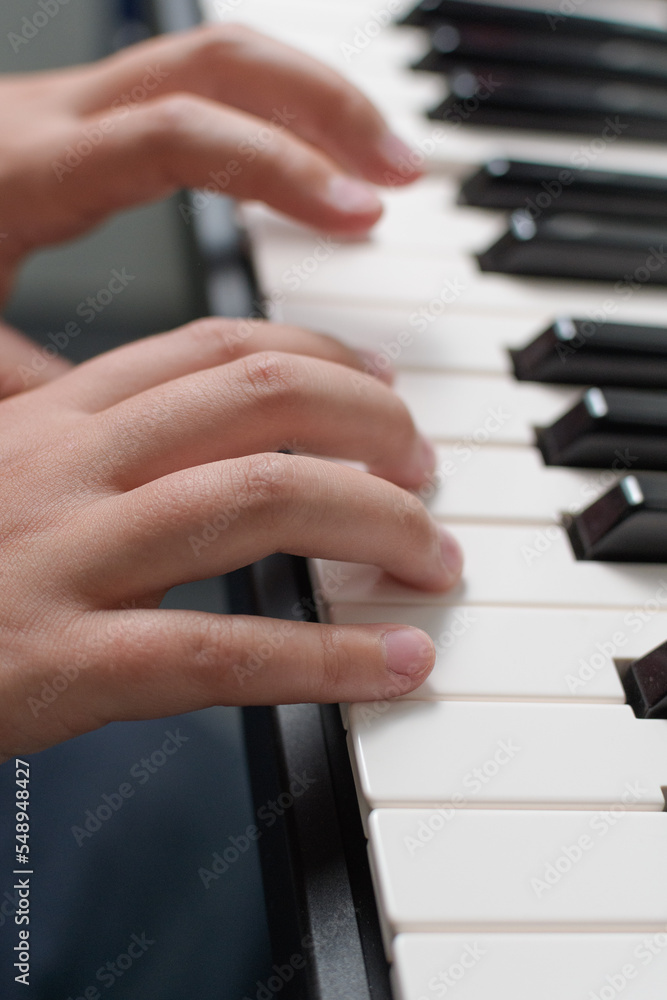 Fototapeta premium Music exercises. Piano two hands playing lessons. Keyboard close-up