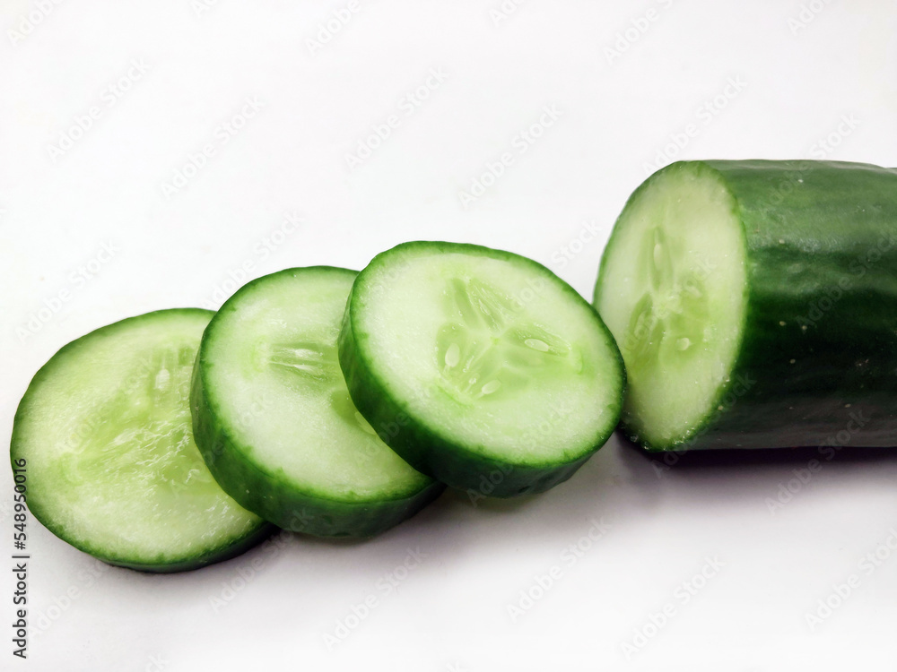 Cucumber with slices. Ripe cucumber on white background. Cucumber with slices. Ripe cucumber on white background.