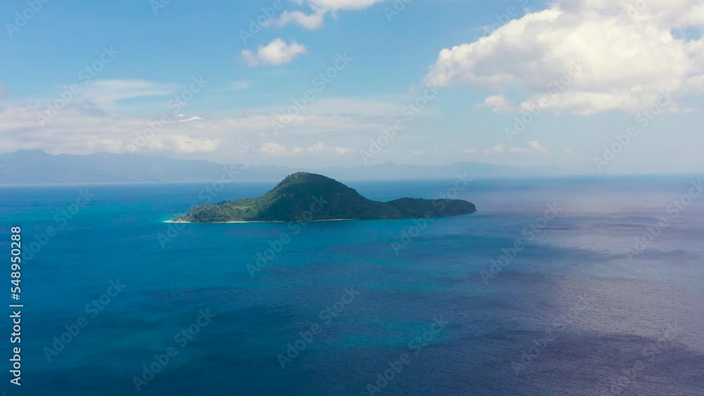 Seascape with a green island. Atulayan Island, Camarines Sur, Philippines. Blue sea with islands, aerial view. Summer and travel vacation concept. Seascape with a green island. Atulayan Island, Camarines Sur, Philippines. Blue sea with islands, aerial view. Summer and travel vacation concept.