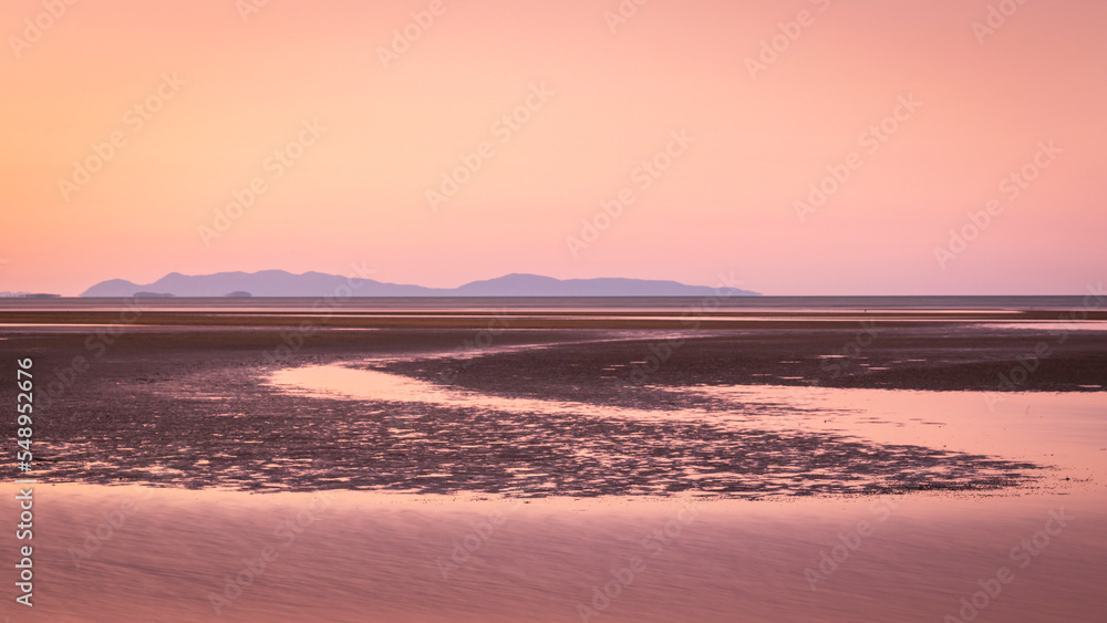 Pink dusk light at bushland beach in townsville queensland