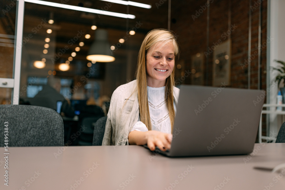 Businesswoman working at the co-working space, using a laptop. Businesswoman working at the co-working space, using a laptop.