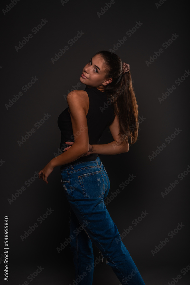 Posing from the back with her hands crossed Posing from the back with her hands crossed