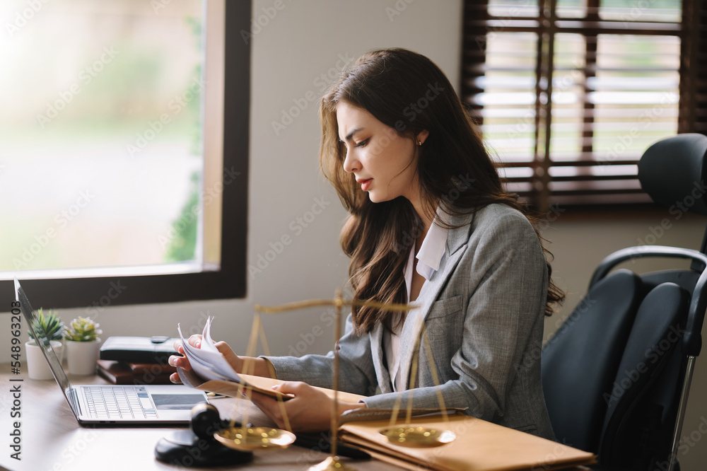 Beautiful asian woman lawyer working and gavel, tablet, laptop in front, Advice justice and law concept.. - obrazy, fototapety, plakaty 