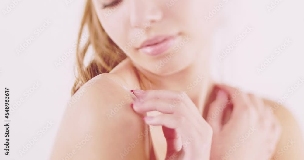 Unrecognizable face of girl with pure skin softly touching her shoulders while applying white cream, selective focus, tilt shift Unrecognizable face of girl with pure skin softly touching her shoulders while applying white cream, selective focus, tilt shift