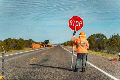 Roadworker holding a stop-sign on a US interstate highway photo