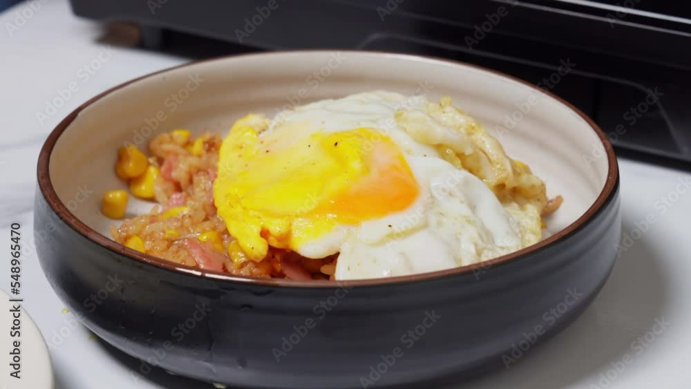 chief cooking dish rice with grilled vegetables, meat and topped with Fried egg, Ingredients for fried rice recipe. Food and cook concept. lunch in restaurant. chief cooking dish rice with grilled vegetables, meat and topped with Fried egg, Ingredients for fried rice recipe. Food and cook concept. lunch in restaurant.