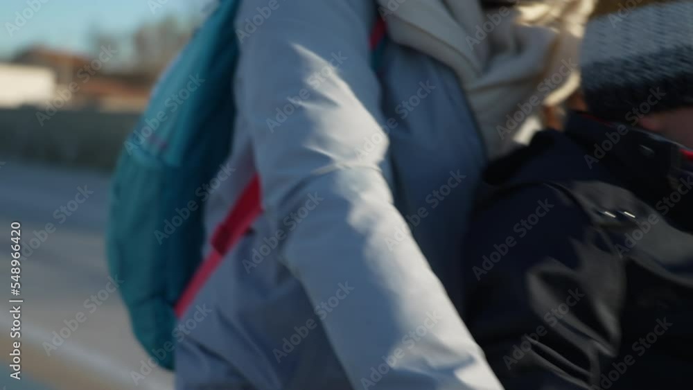 Closeup mother hands holding bicycle handle with child seated in front in baby bike chair riding alternative transportation Closeup mother hands holding bicycle handle with child seated in front in baby bike chair riding alternative transportation