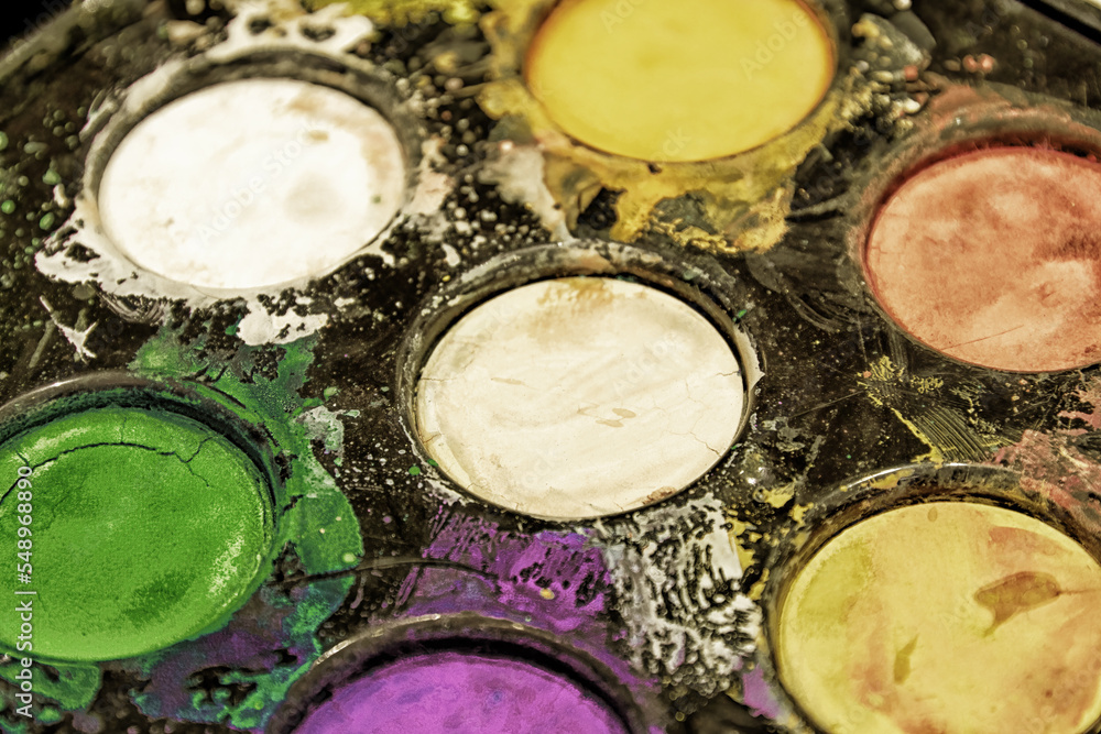 Faded dry dirty palette with green and purple round colors for painting. Arts and hobby backgrounds Faded dry dirty palette with green and purple round colors for painting. Arts and hobby backgrounds