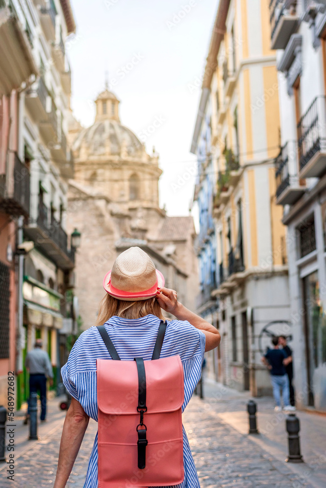 Woman tourist exploring old town of Granada Spain, travel concept. Travel alone