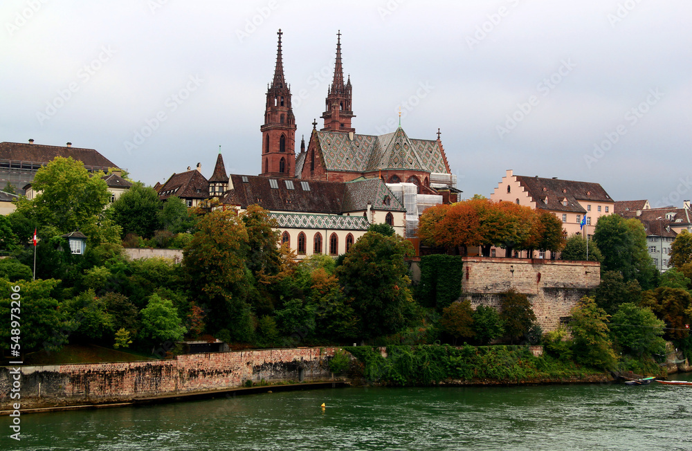View of the Gothic red brick Basel Cathedral and the Rhein River in the city of Basel, northern Switzerland	