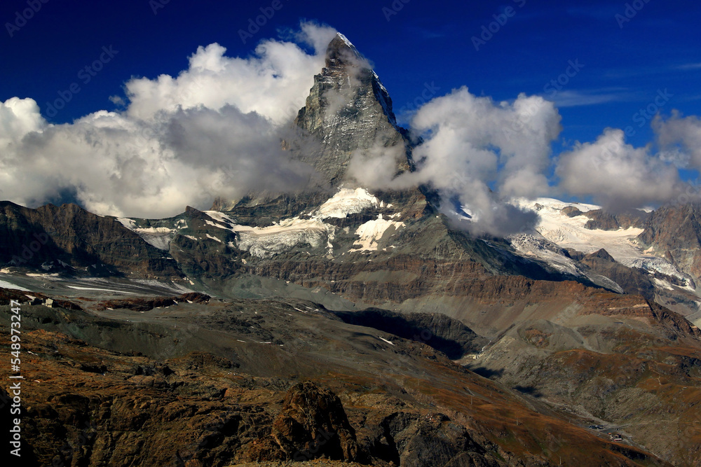 A landscape with a mountain Matterhorn view partially covered by clouds on a mountain Gornergrat, near Zermatt, in southern Switzerland	