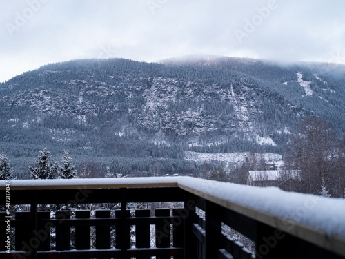 Snowy mountain landscape pictured from a snow-covered porch in Norway