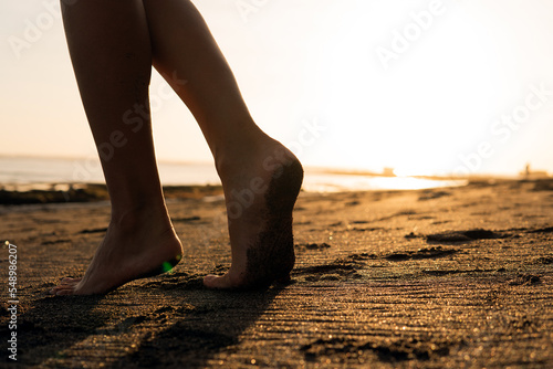 close-up. feet on black sand
