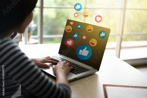 Close up asian woman using computer laptop addiction to technology trends following with emoji on social networks. surrounded by many icons, likes, hearts. Social medias and technology concept.
