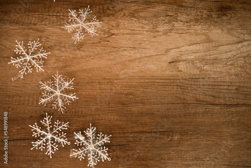 Snowflake on wood, copy space. White snowflakes on wood background. Christmas decoration.