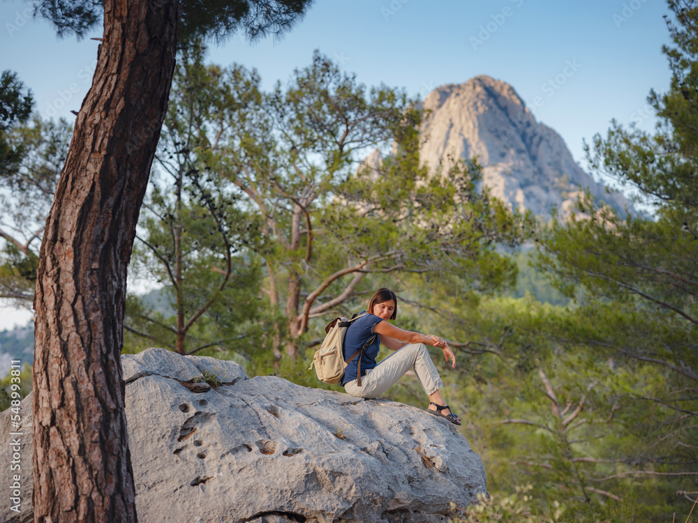 woman traveler walking by Lycian Way trail mountains in Turkey near Antalya. concept of living open-air, physical and mental well-being, digital detox