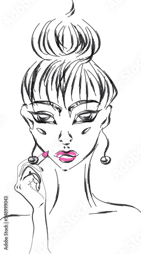 Young girl with hair bun applying pink lipstick on her lips