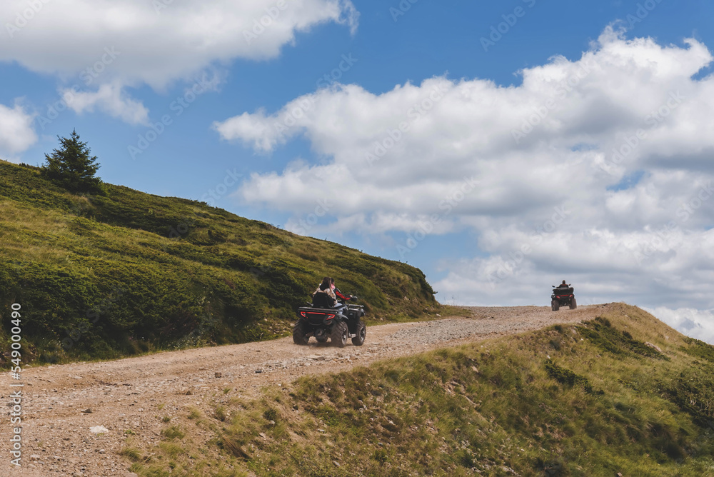 People Driving Quad Bikes on Mountain Hill