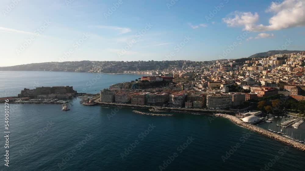 Panoramic drone view of the entire city of Naples in southern Italy. Flight over historical landmarks in Naples, Italy. Historic egg castle (castel dell'ovo) on the waterfront of the Gulf of Naples Panoramic drone view of the entire city of Naples in southern Italy. Flight over historical landmarks in Naples, Italy. Historic egg castle (castel dell'ovo) on the waterfront of the Gulf of Naples