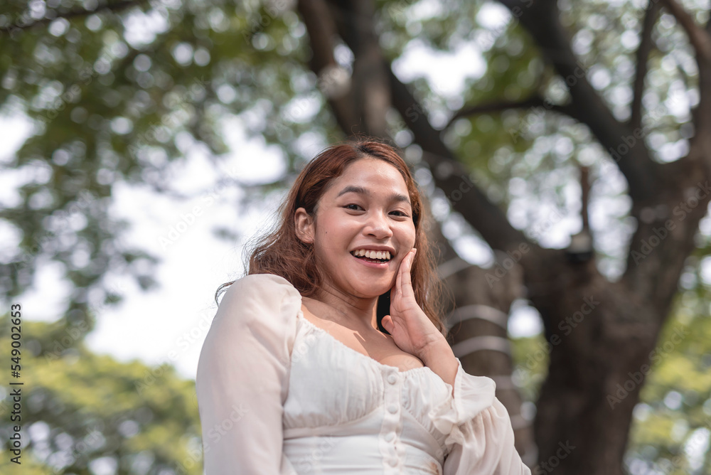 A smiling young lady poses for the camera with an amazed facial expression on a hot afternoon. A smiling young lady poses for the camera with an amazed facial expression on a hot afternoon.