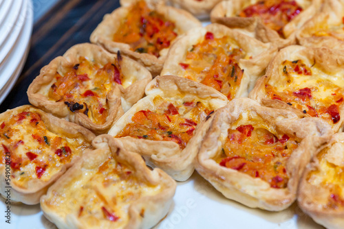 Appetizing mini pizzas at the buffet table. Catering for events, holidays and business meetings. Close-up.