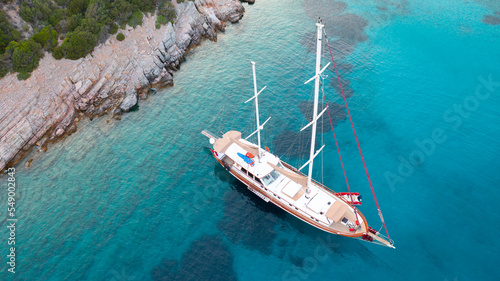 Fototapeta Naklejka Na Ścianę i Meble -  Aerial view of Sailing Gulet. A gulet is a wooden classic yacht built usually in Bodrum or Marmaris from the southwestern coast of Turkey. 