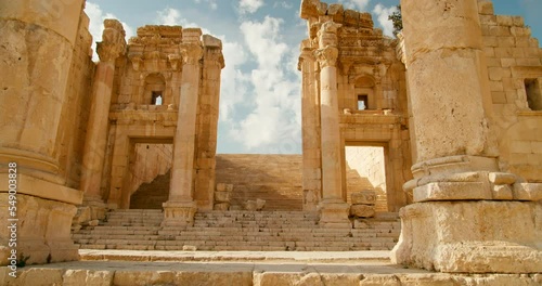 Entering through stairs of Artemis Temple Esplanade with colonnade of columns in Jerash, Jordan. Building created on Roman ruins and one of Seven Wonders. Ancient architecture. 4k zoom shot