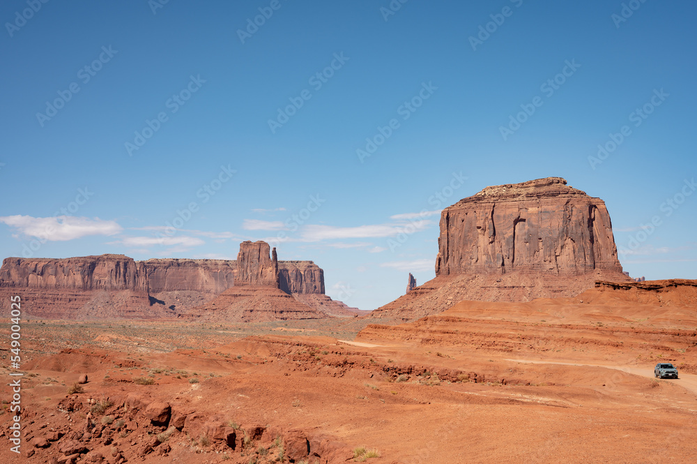 Nice desert landscape with rocky Monument Valley. It's a sunny summer day with blue sky Nice desert landscape with rocky Monument Valley. It's a sunny summer day with blue sky