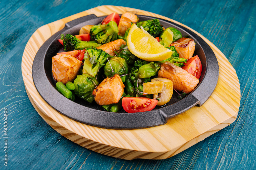 Grilled salmon with vegetables in a pan