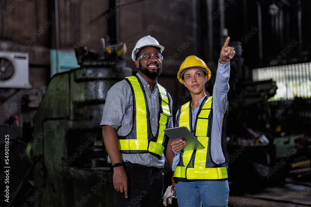 © Tongpool - Maintenance engineer and manager in factory check part available repair machine near welder sparking