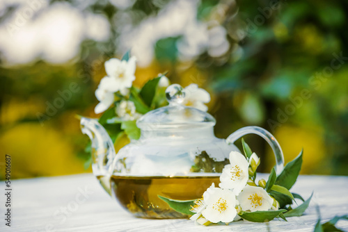 Philadelphus or garden jasmine flowers  healthy herbal tea cup of hot tea. Romantic dinner with therapeutic fragrant tea.