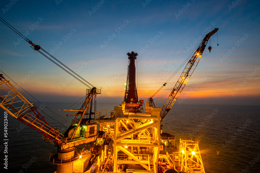 Silhouette, Offshore Jack Up Rig in The Middle of The Sea at Sunset Time